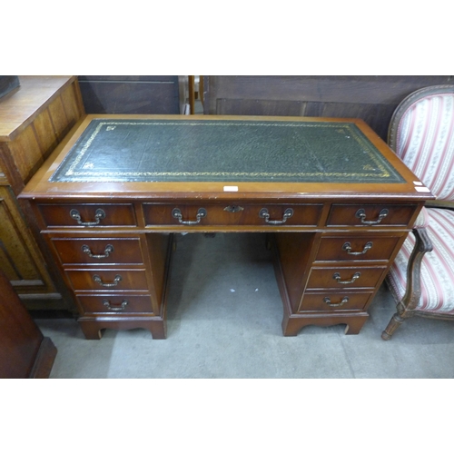 113 - A mahogany and  green leather topped pedestal desk