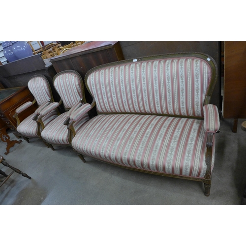 115 - A French carved walnut and striped fabric canape settee and pair of matching fauteuil armchairs