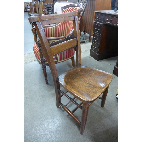 119 - A set of four early 20th Century elm elm and beech chapel chairs