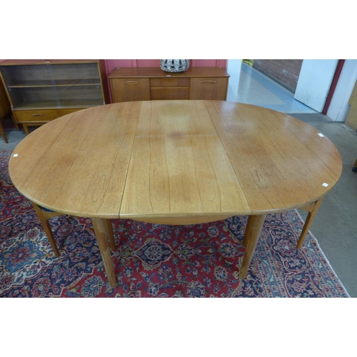 14 - A Nathan teak extending dining table and six chairs