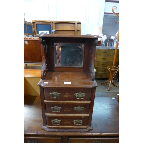 148 - A mahogany counter top haberdashery shop cabinet, bearing Dewhursts Sylko inscription