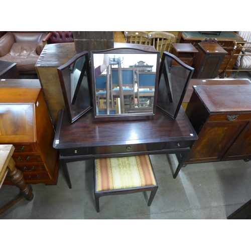 154 - A Stag Minstrel mahogany dressing table and stool