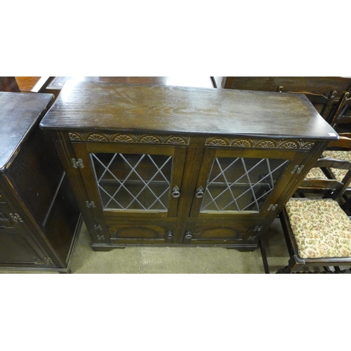 156 - A carved oak dresser, a bookcase, blanket box and and four chairs