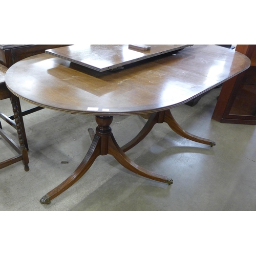 161 - A Regency style mahogany double pedestal extending dining table