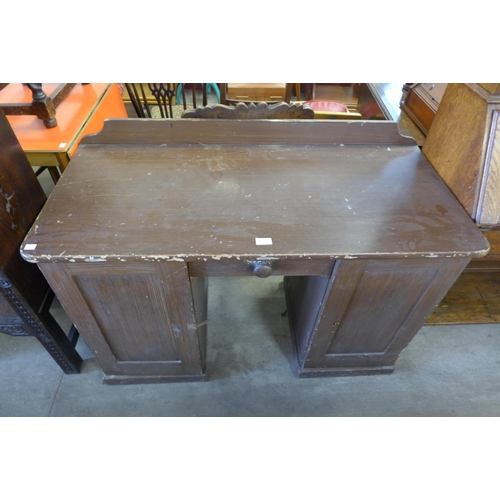 171 - A Victorian stained pine kneehole desk