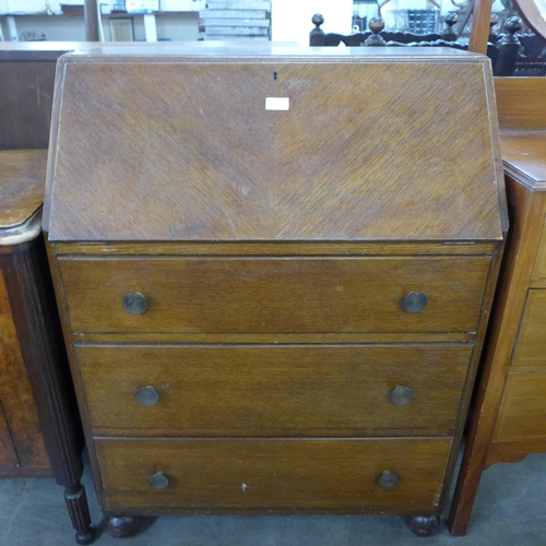 173 - An inlaid walnut gramophone cabinet and an oak bureau