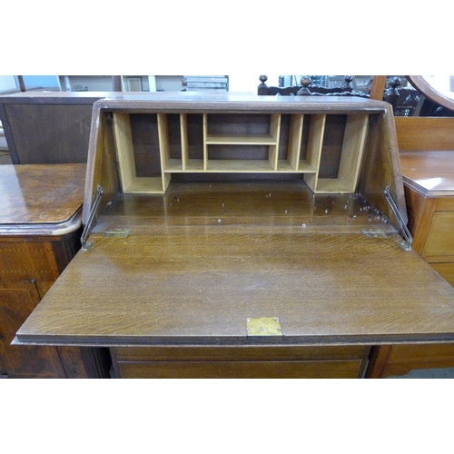 173 - An inlaid walnut gramophone cabinet and an oak bureau