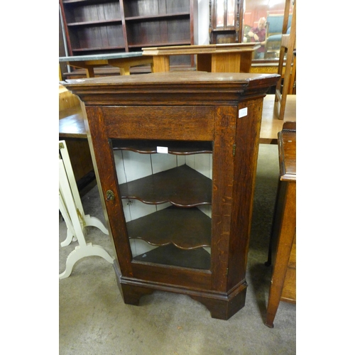 182 - An oak chest of drawers and an oak corner cabinet