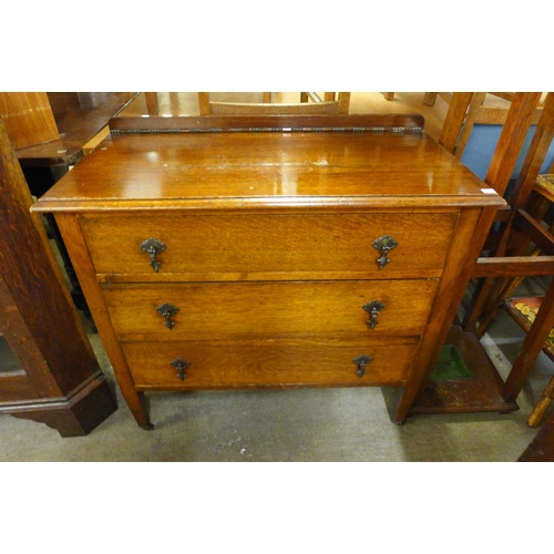 182 - An oak chest of drawers and an oak corner cabinet