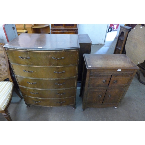 186 - A walnut bow front chest of drawers, an oak cabinet and a standard lamp