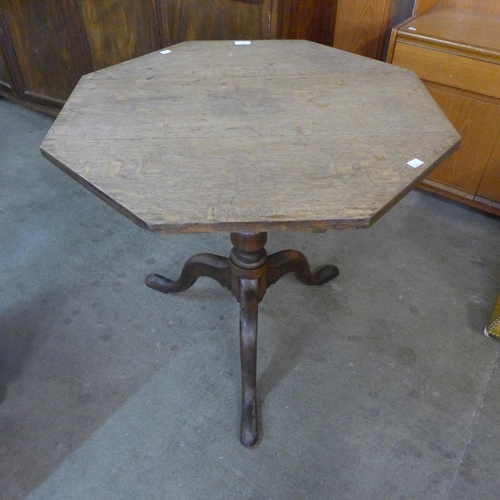 189 - A George III oak octagonal tilt-top tripod tea table