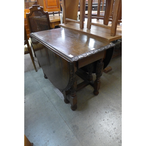 196 - A carved oak gateleg table