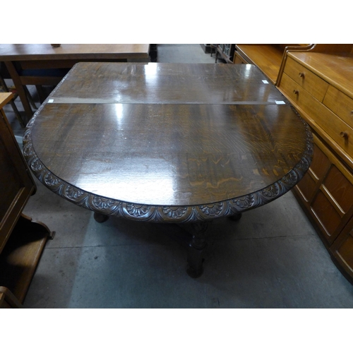 196 - A carved oak gateleg table