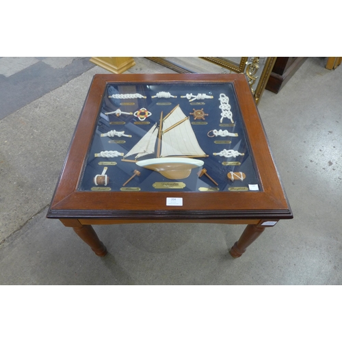 204 - A nautical themed glass topped coffee table