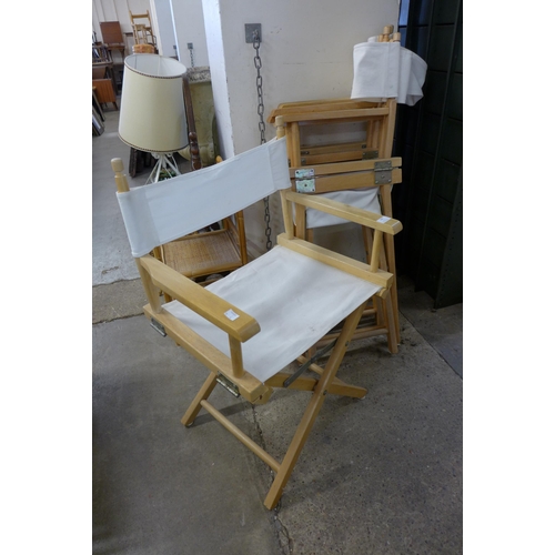 208 - A set of four beech folding director's chairs