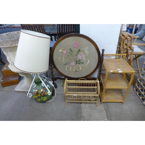 209 - A carboy table lamp, a bamboo magazine rack and plant stand and an oak fire screen