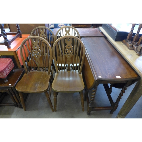 219 - An oak barleytwist gateleg table and four beech chairs