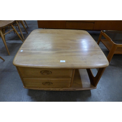 22 - An Ercol Blonde elm Pandora's box coffee table