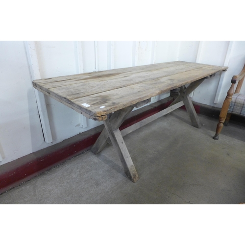 227 - A Gothic pine x-frame farmhouse refectory table