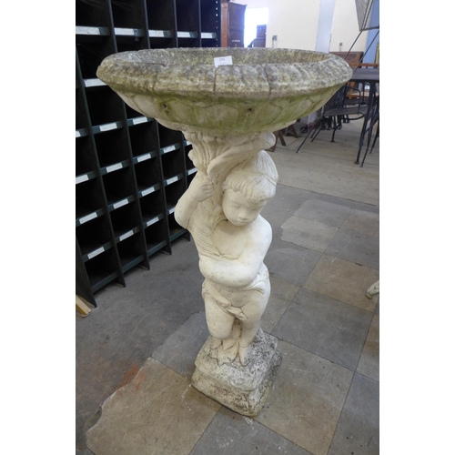 234 - A figural cherub concrete bird bath