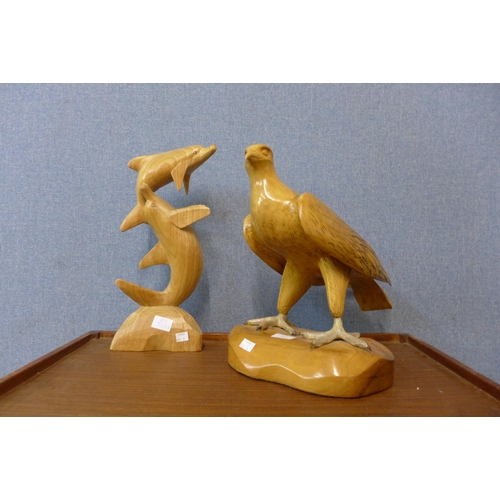 271 - Two carved wooden figures, eagle and dolphins