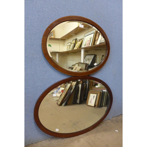 276 - Two oval mahogany framed mirrors