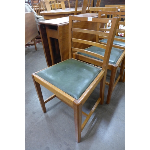 37 - A teak drop leaf table and three oak chairs