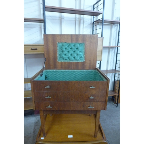 74 - A teak trolley and a sewing box