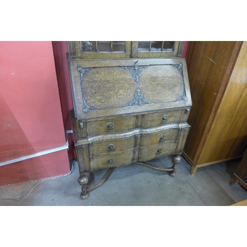 77 - An early 20th Century oak cantilever action bureau bookcase