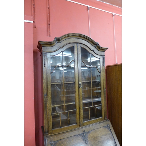 77 - An early 20th Century oak cantilever action bureau bookcase