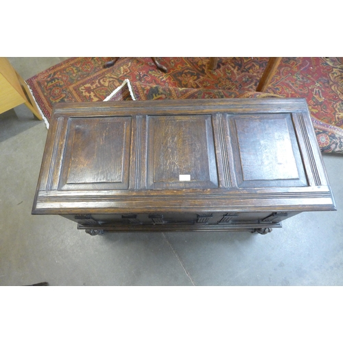 81 - A 17th Century style carved oak blanket box on stand