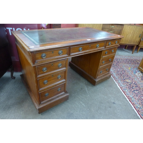 88 - A Victorian mahogany and green leather topped pedestal desk