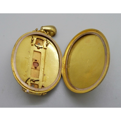 1004 - A large Victorian coral and diamond set locket, (tests as high carat gold), 37.1g, 39mm wide