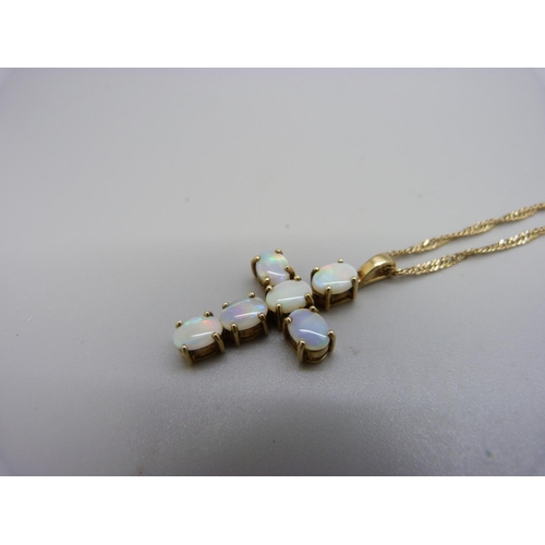 1016 - A 9ct gold an opal set cross pendant and chain, 5.2g