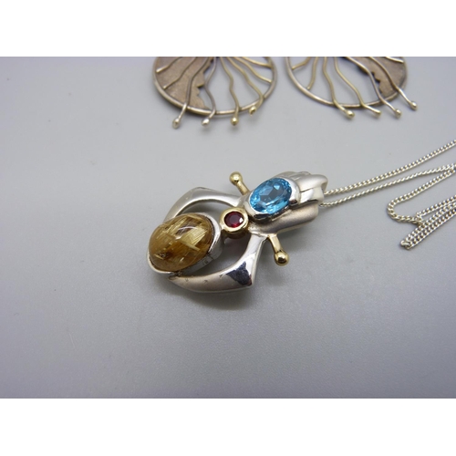 1026 - A pair of silver earrings set with topaz and a 925 silver pendant set with blue, red and one other s... 