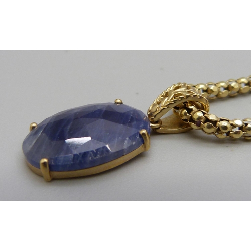 1029 - A 9ct gold faceted blue stone set pendant on a silver chain