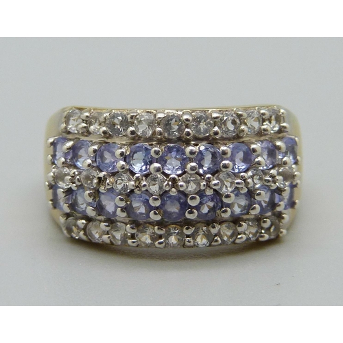 1035 - A silver gilt, tanzanite and white stone ring, O