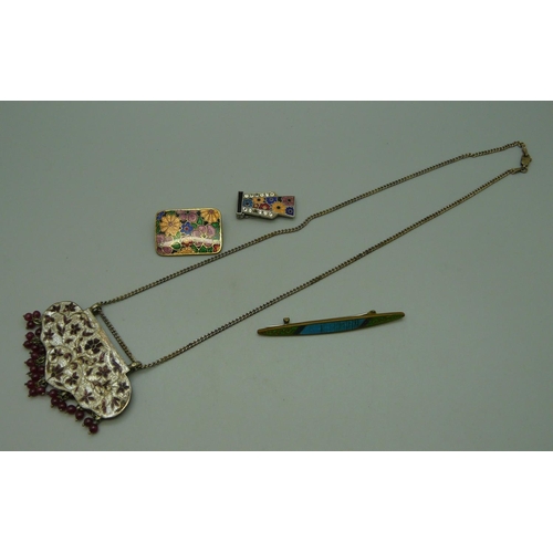 1041 - An enamelled necklace, two brooches and a clip (one stone missing)