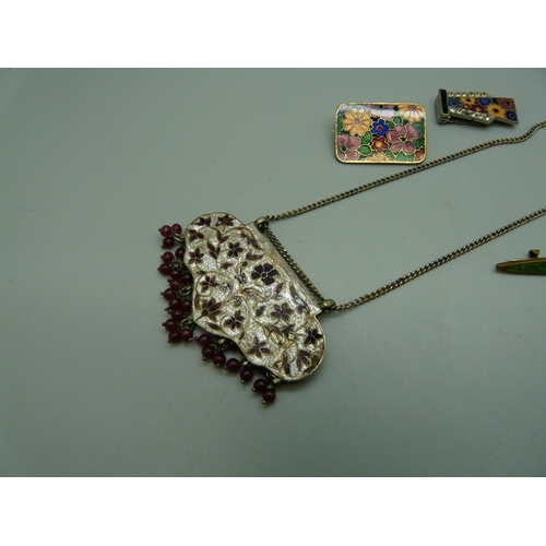 1041 - An enamelled necklace, two brooches and a clip (one stone missing)