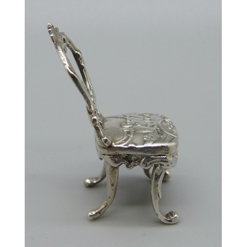 1050 - A silver miniature dolls house chair, London import marks for 1895