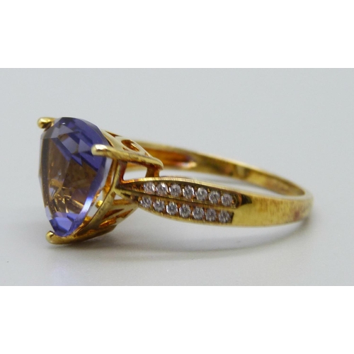 1052 - A silver gilt, trilliant cut purple stone and white stones ring, R