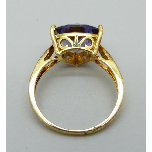 1052 - A silver gilt, trilliant cut purple stone and white stones ring, R