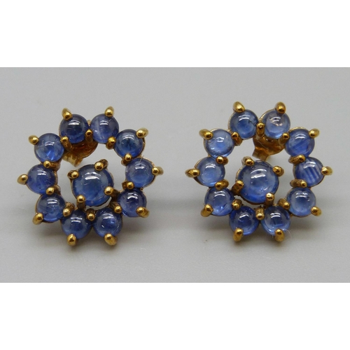 1061 - A pair of 9ct gold cabochon blue stone set earrings, 4.2g