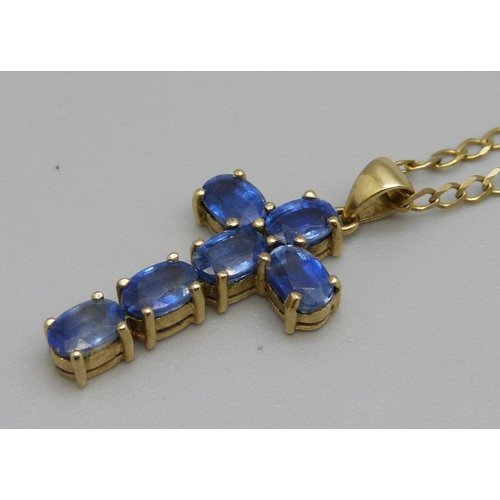 1062 - A 9ct gold and blue stone cross pendant on a 9ct gold fine curb chain, 5.1g