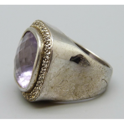 1067 - A large silver set ring with an amethyst coloured stone, N