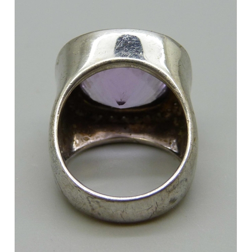 1067 - A large silver set ring with an amethyst coloured stone, N