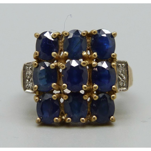 1068 - A 9ct gold ring set with blue and white stones, 5.6g, N