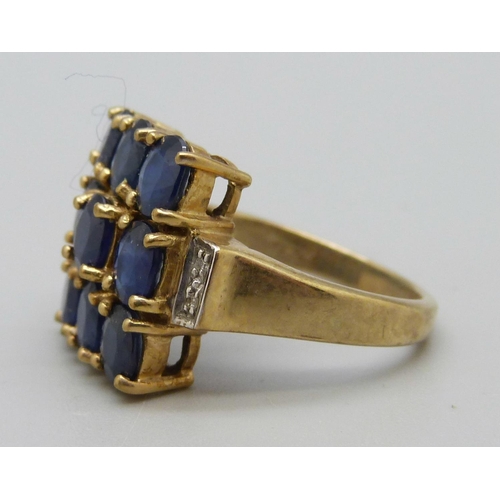 1068 - A 9ct gold ring set with blue and white stones, 5.6g, N