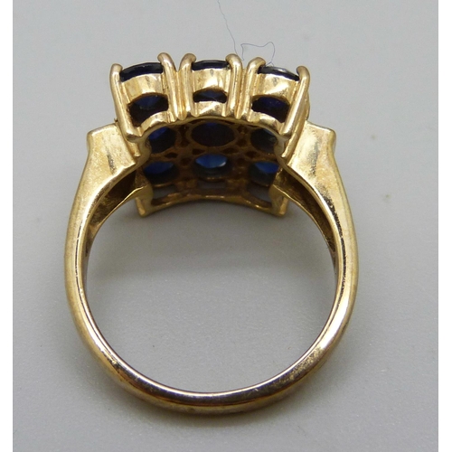 1068 - A 9ct gold ring set with blue and white stones, 5.6g, N