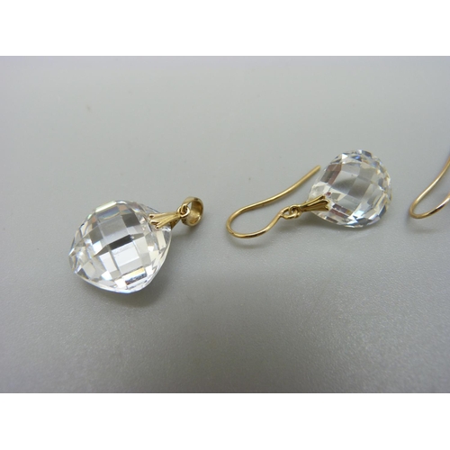 1077 - A pair of 14ct gold set of CZ earrings and a matching pendant